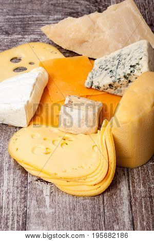 Different type of cheese on wooden background. Gourmet food apetizer