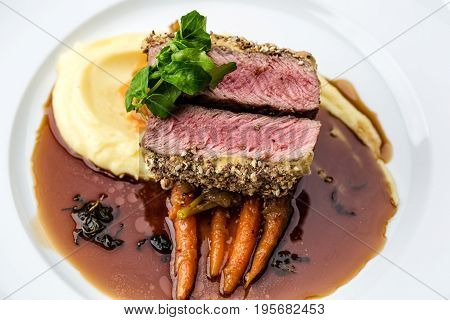 medium done grilled tuna steak in batter served with the baby carrot and mashpotato