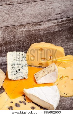 Different type of cheese on wooden background. Gourmet food apetizer