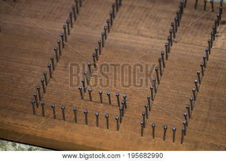 Nail being driven into wood by hammer head.