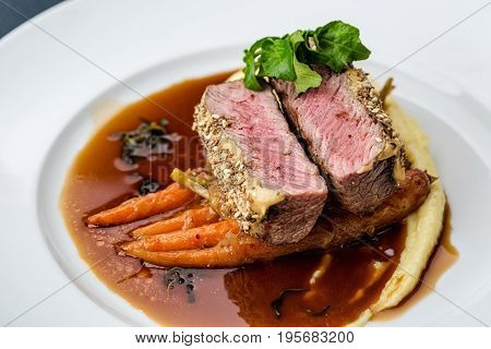 medium done grilled tuna steak in batter served with the baby carrot and mashpotato