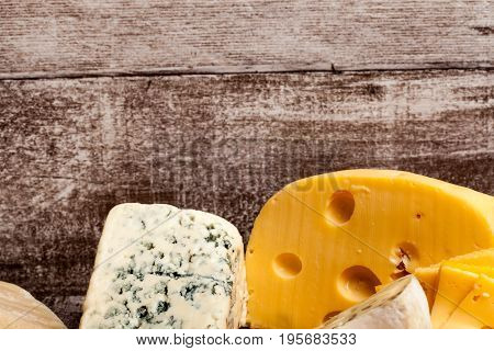 Different type of cheese on wooden background. Gourmet food apetizer