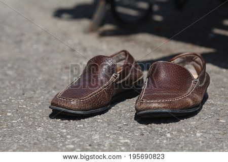 leather top sider shoes on stone ground