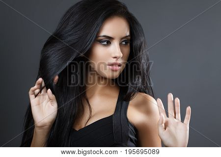 Beautiful Model Girl With Smooth Dark Hair. Perfect Hair. Black Dress.