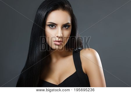 Beautiful Model Girl With Smooth Dark Hair. Perfect Hair. Black Dress