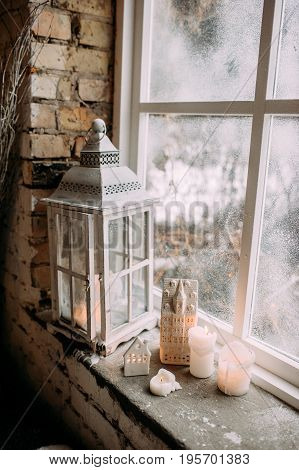 White Latern And Candles On The Windowsill