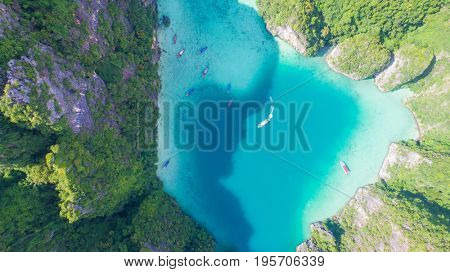 Aerial drone view of iconic tropical turquoise water Pileh Lagoon surrounded by limestone cliffs, Phi Phi islands, Thailand