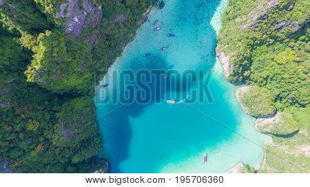 Aerial drone view of iconic tropical turquoise water Pileh Lagoon surrounded by limestone cliffs, Phi Phi islands, Thailand