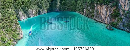 Aerial drone view of iconic tropical turquoise water Pileh Lagoon surrounded by limestone cliffs, Phi Phi islands, Thailand