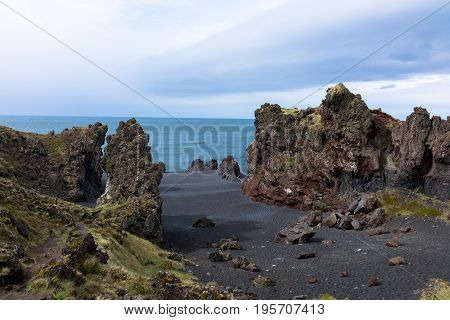 Djupalonssandur is a beautiful pebbled beach with a series of rocks of mysterious form emerging from the ocean