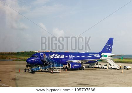 Grenada June 26 2017: JetBlue airplane is being prepared by ariport crew for its flight to NYC.