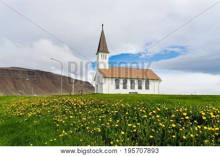 Reykholakirkja or church seen here surrounded by flowers in Reykholar Iceland
