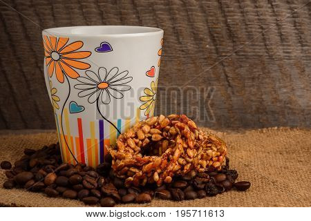 Cup Of Coffee, Biscuits And Coffee Beans On A Wooden Background