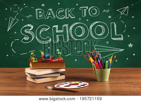Back to school concepty with writing on blackboard and desk, apple, books, items
