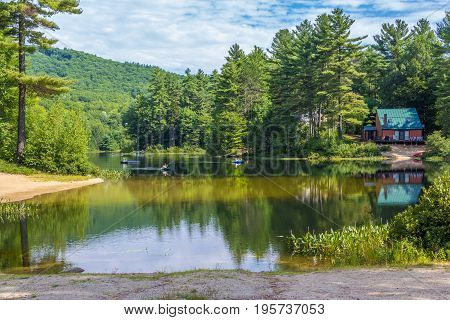 Scenic pond with mountain background where you can kayak and swim
