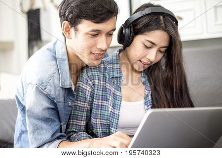 Young Man Using Laptop And Woman With Happy Emoyion At Living Room People Lifestyle Concept.