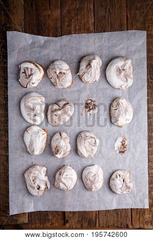 Homemade marble chocolate meringue cookies on a baking sheet. Top view.