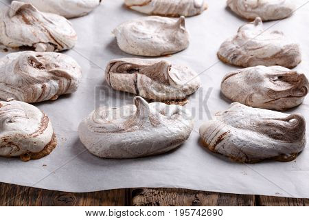 Homemade marble chocolate meringue cookies on a baking sheet