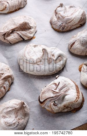 Homemade marble chocolate meringue cookies on a baking sheet