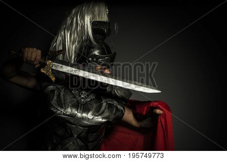 Caesar, Roman centurion with armor and helmet with white chalk, steel sword and long red cape