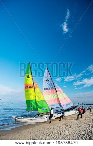 Windsurfer Or Man Sportsman Surfs And Sails On Board