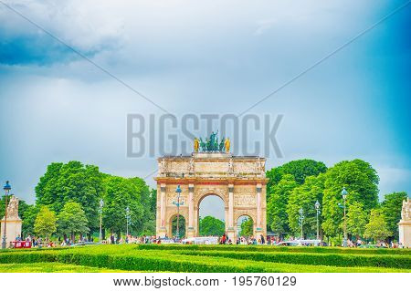Paris France-June 1 2016 : Triumphal Arch (Arc de Triomphe du Carrousel) at Tuileries gardens in Paris France. Monument was built between 1806-1808 to commemorate Napoleon's military victories.