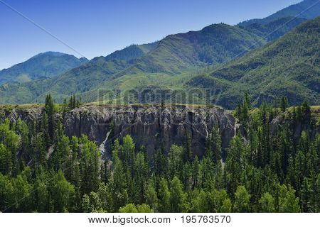 Steep green hills and forest in Altai mountains. Altay Republic Siberia Russia.