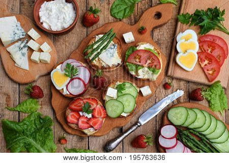 Set Of Healthy Whole Wheat Bread Sandwiches With Fuits, Vegetables, Cheese And Leafy Green Herbs On