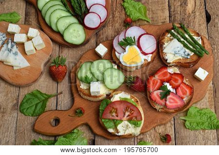 Set Of Healthy Whole Wheat Bread Sandwiches With Fuits, Vegetables, Cheese And Leafy Green Herbs On