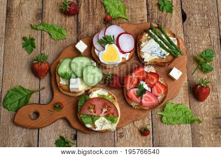 Set Of Healthy Whole Wheat Bread Sandwiches With Fuits, Vegetables, Cheese And Leafy Green Herbs On