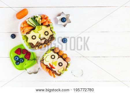 School lunch box for kids on white wooden background. Back to school. Top view flat lay