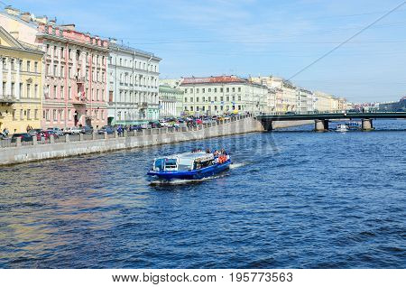SAINT PETERSBURG RUSSIA - MAY 1 2017: Unknown tourists are on excursion boats on Fontanka River near Semyonovsky bridge St. Petersburg Russia