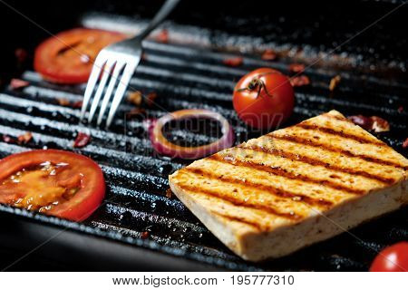 ofu on the grill on the table on a black background, view from the top