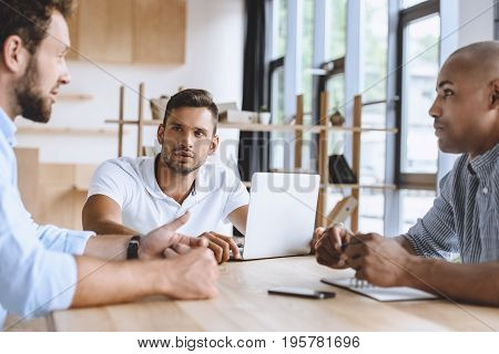 Multicultural Business People Discussing Business Strategy While Working In Office
