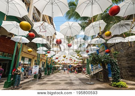 Port Louis Mauritius - December 25 2015: Display of white umbrellas in Caudan Waterfront Mall Port Louis Mauritius.