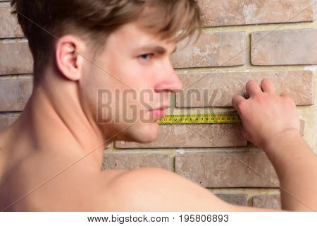 Man With Naked Body Holds Yellow Self Retracting Tape Measure