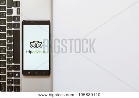 Los Angeles, USA, july 18, 2017: Tripadvisor logo on smartphone screen placed on the laptop on white background.