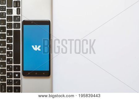 Los Angeles, USA, july 18, 2017: Vkontakte logo on smartphone screen placed on the laptop on white background.