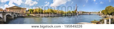 Panoramic view of Paris over river Seine with Alexander III bridge Tour Eiffel and Assemblee Nationale. Copy space in blue sky.