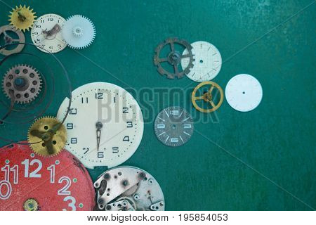 Creative composition with parts of mechanical clock on grunge background