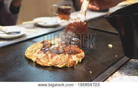 Chef Cooking okonomiyaki in Tokyo - Japan
