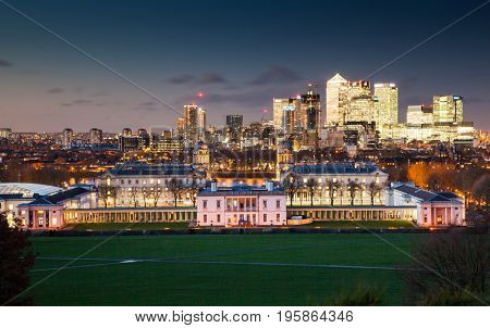 London, UK - JANUARY 7, 2016: Panoramic view from Greenwich on Canary Wharf financial district with skyscrapers at night. View includes the park, National Maritime Museum, Royal chapel and O2.