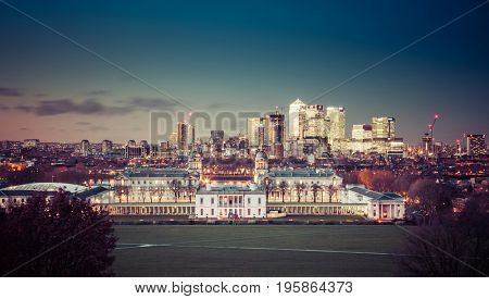 London, UK - JANUARY 7, 2016: Panoramic view from Greenwich on Canary Wharf financial district with skyscrapers at night. View includes the park, National Maritime Museum, Royal chapel and O2.