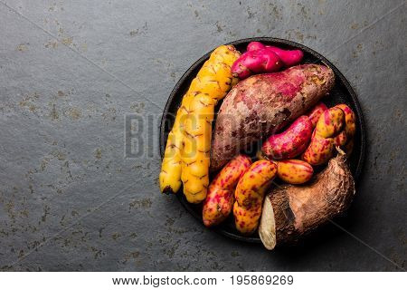 Peruvian raw ingredients for cooking - yuca, colored sweet potatoes and camote batata. Top view.