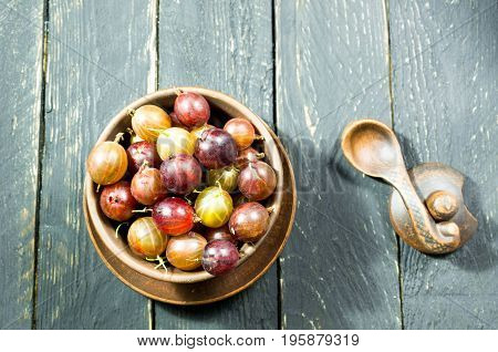 Many Berries In The Plate. Gooseberry. Top View. Dark Background. Decorative Photo.