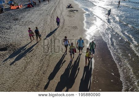 KOLOBRZEG, WEST POMERANIAN / POLAND: Walk the sea beach at sunset