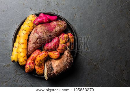 Peruvian Raw Ingredients For Cooking - Yuca, Colored Sweet Potatoes And Camote Batata. Top View