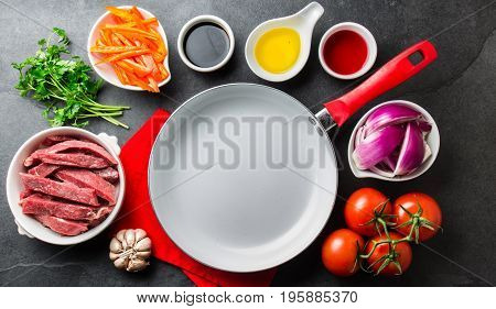 Ingredientes For Cooking Peruvian Dish Lomo Saltado - Tenderloin Beef, Vegetables Around White Pan.
