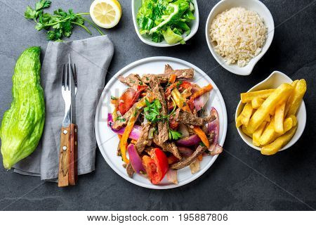 Peruvian Dish Lomo Saltado - Beef Tenderloin With Purple Onion, Yellow Chili, Tomatoes Served On Whi