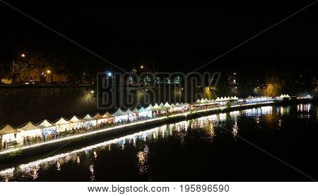 ROME ITALY - JUNE 25 2017: Lungotevere near the Tiber Island people enjoy the summer night among trendy bars